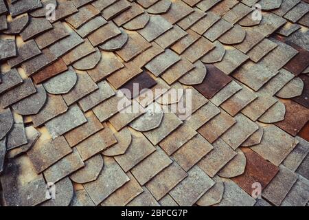 Close up roof tiles texture for background. Old Fashioned style Roof Tiles rows. English vintage ceramic tiles of various shapes Stock Photo