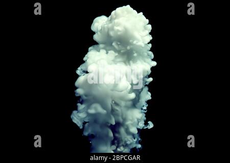 Blue and white ink motion on dark background, mixing and swirling waves with water, abstract backdrop. Stock Photo