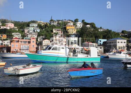 St George's Grenada Carenage Harbour Man in Small Boat with Fishing Line Stock Photo