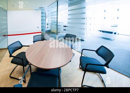 Empty small meeting room. Bright modern interior. Glass walls Stock Photo