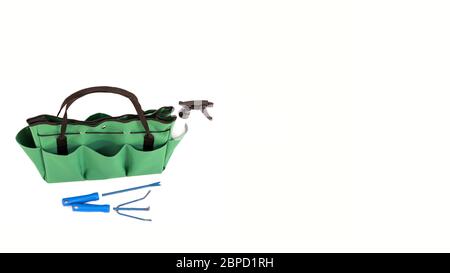 Isolated green handbag. Green bag multi purpose with pockets. Green bag for gardening with tools. Copy space. Green handbag on a white background. Fas Stock Photo