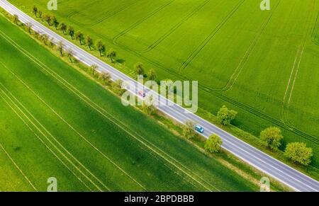 15 May 2020, Saxony-Anhalt, Bad Kösen: Cars drive along a country road between two green fields. (aerial photo with drone) Photo: Jan Woitas/dpa-Zentralbild/ZB Stock Photo