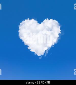 Heart shape cloud in the sky. One white cloud in a blue sky. Romantic love and health symbol Stock Photo
