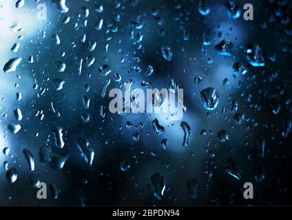 Vibrant raindrops on window glass background Stock Photo