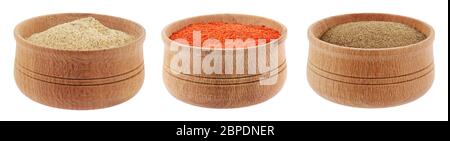 Different kind of pepper powder, white, black, red in wooden bowls isolated on white Stock Photo