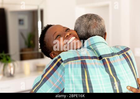 Senior African American couple embracing, smiling and looking at camera Stock Photo
