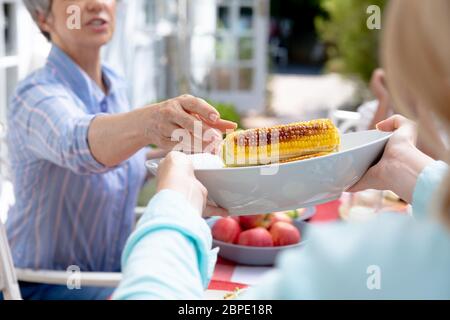 Caucasian family sitting at table during a family lunch in the garden Stock Photo