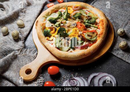 Vegetarian pizza with greens and broccoli, zucchini and pepper. Slimming pizza. Stock Photo