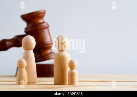 Wooden toy family and judge mallet. Family divorce concept Stock Photo