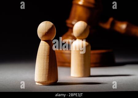 Wooden toy family and judge mallet. Family divorce concept Stock Photo