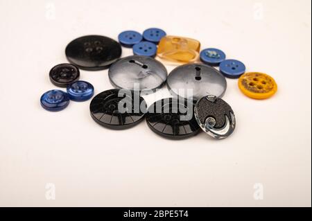 Several multi-colored buttons of different sizes on a white background. Close up Stock Photo