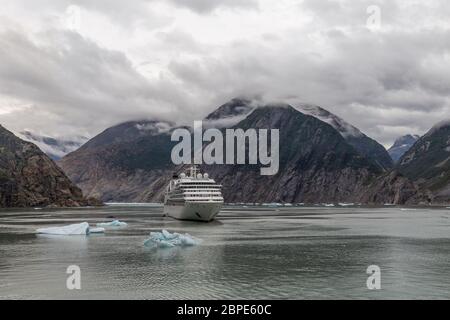 Seabourn Sojourn cruise ship drifting with small icebergs floating around in Tracy Arm Fjord in Alaska, USA Stock Photo