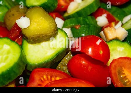 Vegetable salad sliced tomatoes, cucumbers, onions and pickles. Close up. Healthy food, fitness diet Stock Photo