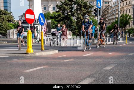 Bucharest/Romania - 05.16.2020: People riding bicycles on a bicycle lane in the center of Bucharest. People enjoying a nice day in the center of Bucha Stock Photo