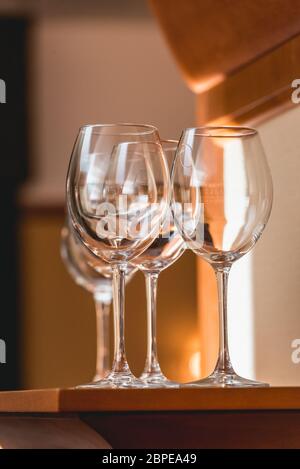 Empty wine glasses on the wooden table, reflection in the glass Stock Photo