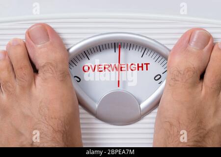 Man's feet on weight scale - Time for gym Stock Photo by ©michaklootwijk  159795848