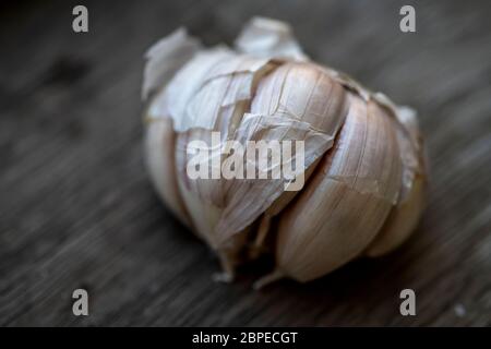 Few garlic bulbs and cloves over a wood table Stock Photo