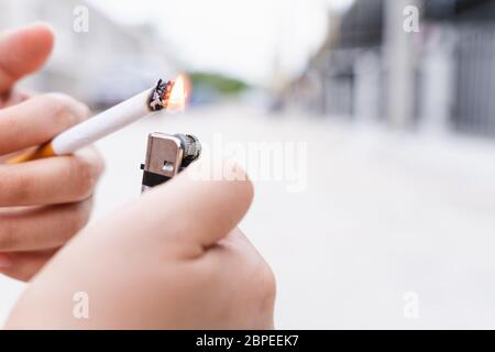light cigarette with no lighter Close-up of someone light a cigarette. World no tobacco day concept Stock  Photo