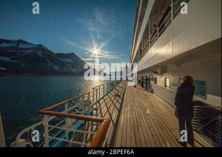 Abendstimmung an Bord eines Kreuzfahrtschiffs in den Fjorden Norwegens mit Spiegelung der Berge im Wasser Stock Photo