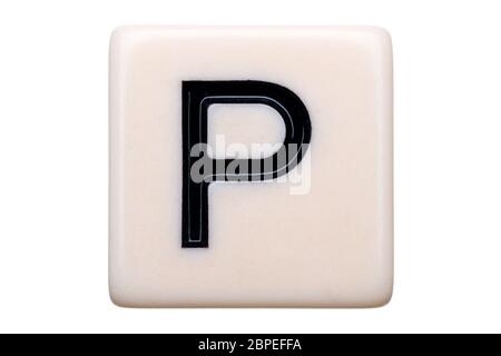 A macro shot of a game tile with the letter P on it on a white background. Stock Photo