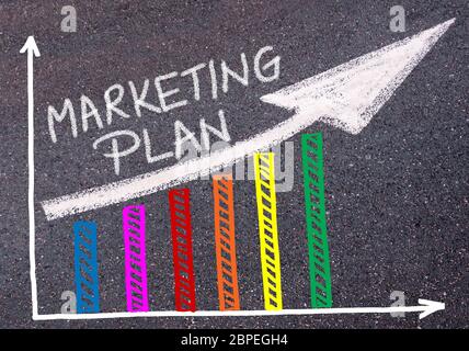 MARKETING PLAN written with chalk on tarmac over colorful graph and rising arrow, business marketing and creativity concept Stock Photo