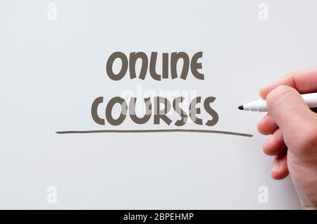 Human hand writing online courses on whiteboard Stock Photo