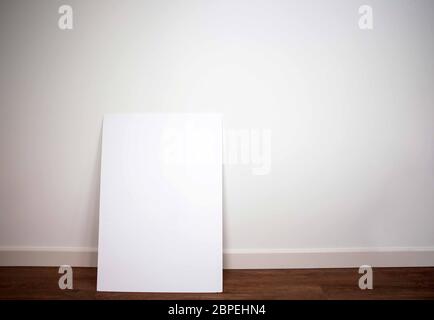 Blank canvas,poster or board against white wall on pvc floor in modern interior, empty room space for text Stock Photo
