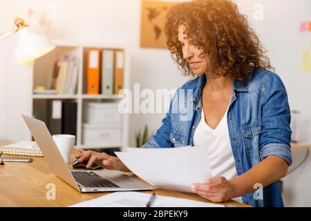 Middle age woman working at the office Stock Photo