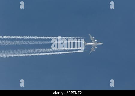 Plane at cruising altitude against blue sky Stock Photo