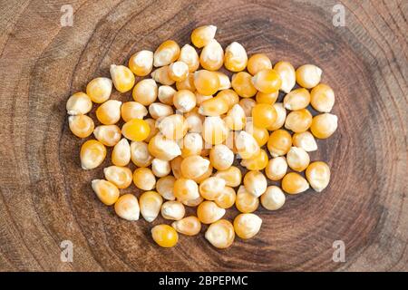 Raw corn kernel on wooden background. Flat lay composition. Healthy, organic and delicious food. Stock Photo