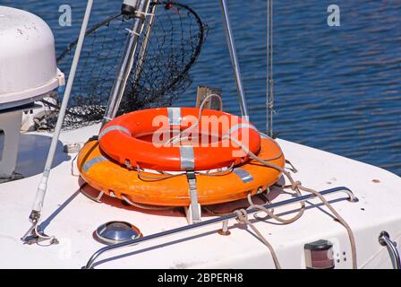 Two life belts on top of cabin of small moored vessel, Exmouth, Devon, England Stock Photo