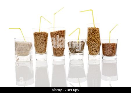 Different kinds of seeds and grains for healthy milk -  rice, soya, hemp, buckwheat and wheat milk. Grains in glasses isolated. Vegetarian and vegan m Stock Photo