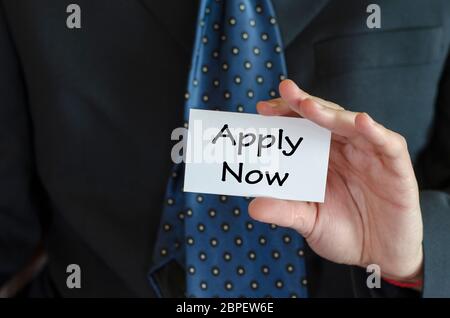 Apply now text note concept over business man background Stock Photo