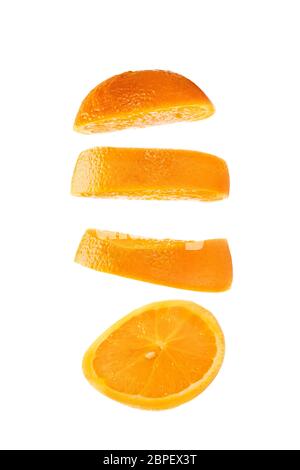 Sliced orange floating on white background. Fruit slice falling on bright backdrop. Stock Photo