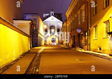 Picturesque Street and Gate of Dawn at night in Old Town of Vilnius, Lithuania, Baltic states. Used toning Stock Photo