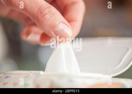 Hand picked a wet wipes in package box, Wet wipes in a woman's hand Stock Photo