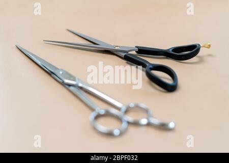 Professional hairdresser tools on brown background. Classic barber equipment - scissors Stock Photo