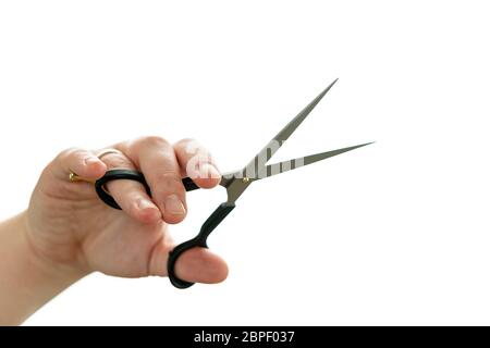 Close up of professional hairdresser holding scissors isolated on white background. Barber work tool - scissors on bright backdrop with space for text Stock Photo