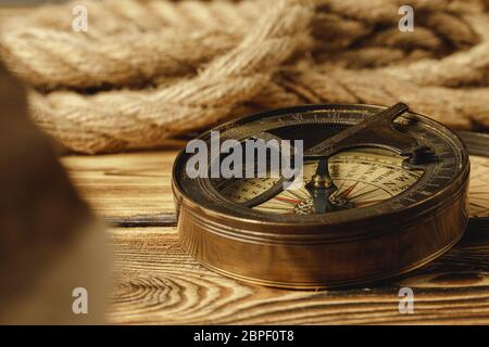 Ship rope and compass on wooden background Stock Photo