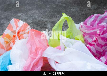 Colorful plastic bags on cement floor background Stock Photo