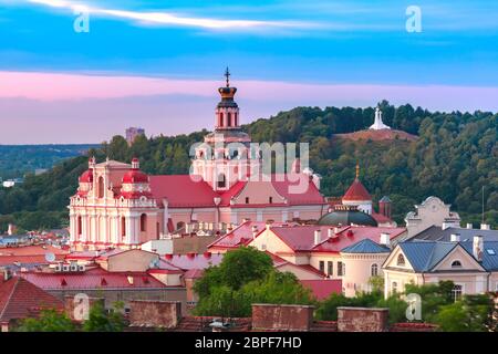 Aerial view over Old town with Church of St Casimir and Three Crosses on the Bleak Hill at sunset, Vilnius, Lithuania, Baltic states. Stock Photo