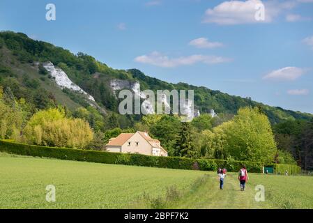 People hiking near a cliff close to river Seine and the village of La Roche Guyon in Vexin regional national park, Val d'Oise, Ile de France near Pari Stock Photo