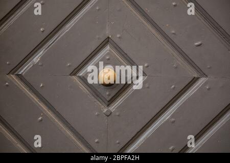 Old door of a historical building with iron door knob Stock Photo