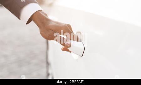 African Man Opening Auto Door Outdoors, Closeup, Cropped Stock Photo