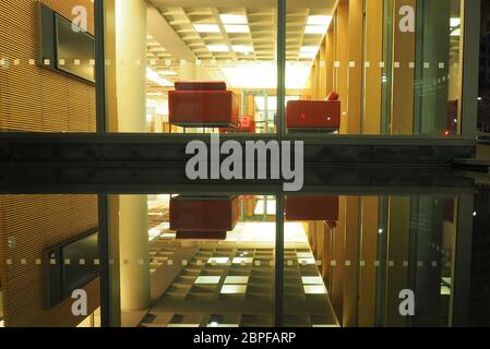 An interior of the Supreme Court New Zealand is reflected in the shallow moat on the outside of this modern building Stock Photo
