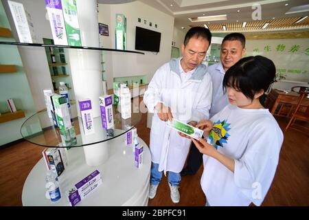 Suiyang, China's Guizhou. 18th May, 2020. A sales staff (1st R) introduces products to clients in a toothpaste company at an economic development zone in Suiyang, southwest China's Guizhou, May 18, 2020. The economic development zone in Suiyang has resumed work and production. By mid-May, its production value has reached 990 million yuan (139.2 million U.S. dollars). Credit: Yang Ying/Xinhua/Alamy Live News Stock Photo