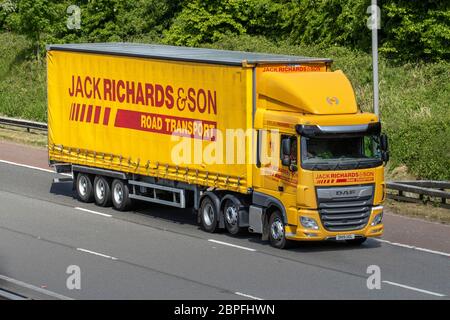 Jack Richards & Son Haulage delivery trucks, lorry, transportation, truck,yellow cargo carrier, DAF vehicle, European commercial transport, industry, M6 at Manchester, UK Stock Photo