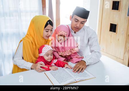 Asian family learn Quran bible together when spare time in the holiday Stock Photo