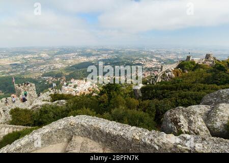 Scenic view of the medieval hilltop castle Castelo dos Mouros (The Castle of the Moors), old town and beyond in Sintra, Portugal. Stock Photo