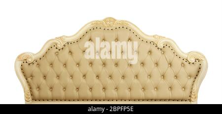 Shaped pastel beige color soft tufted leather capitone bed headboard of Chesterfield style sofa with carved wooden frame, isolated on white background Stock Photo